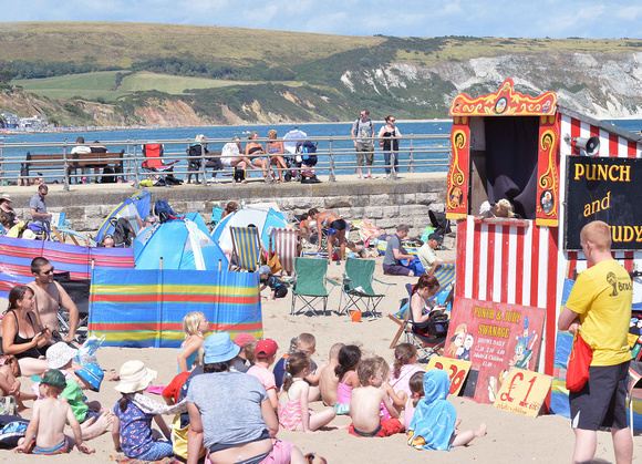 2. Punch and Judy on Swanage Main beach with back-drop of  Ballard Down